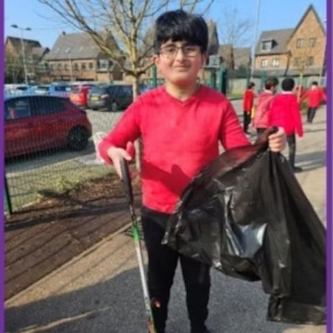 A student litter picking with friends